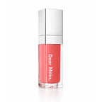 Luminous liquid blush acrylic bottle with silver cap and a peachy coral blush shade inside on a white background with the Dear Māia logo