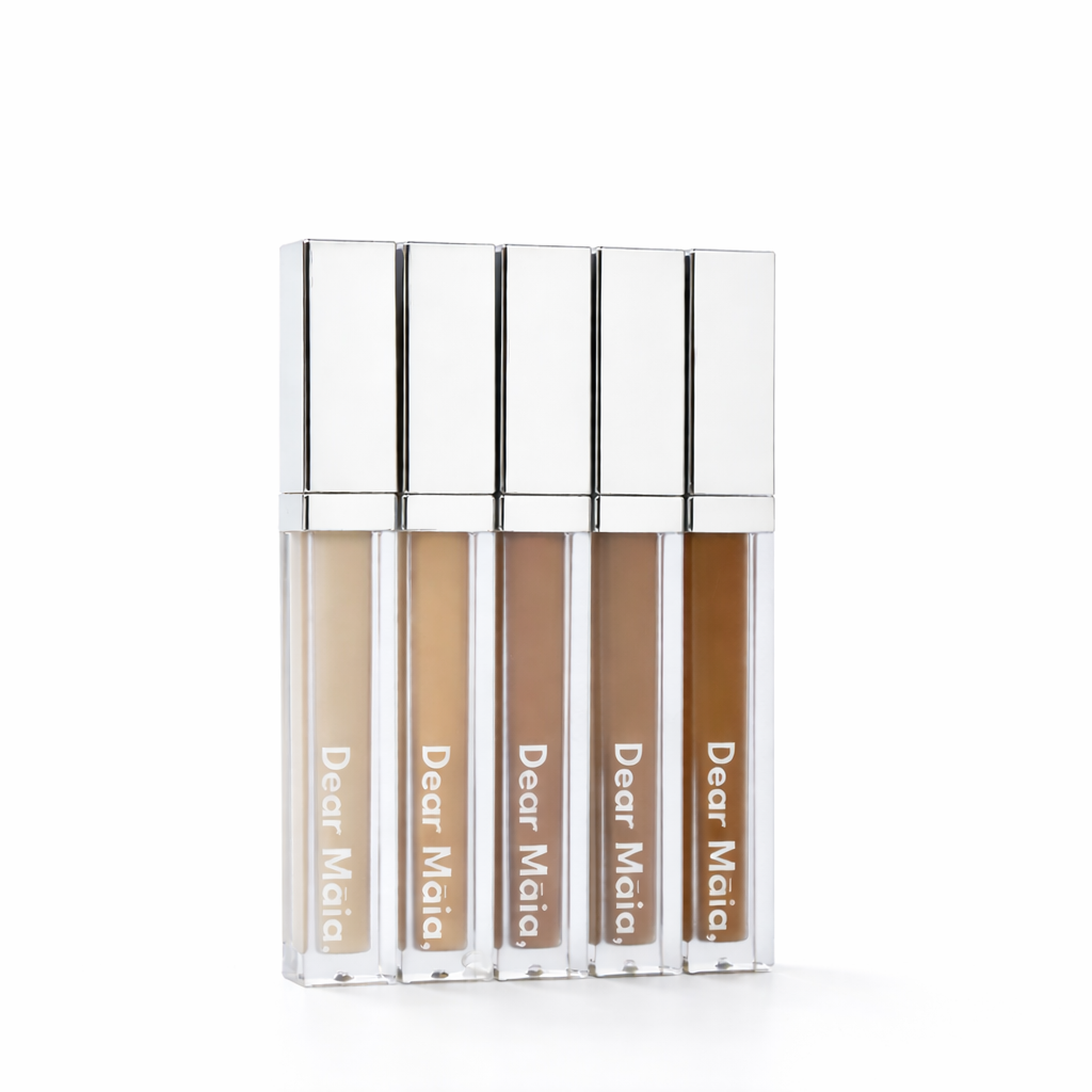 Five concealer tubes with 'Dear Mala' branding on a white background. Displaying the five shades of the flawless awakening concealer ranging from light to deep