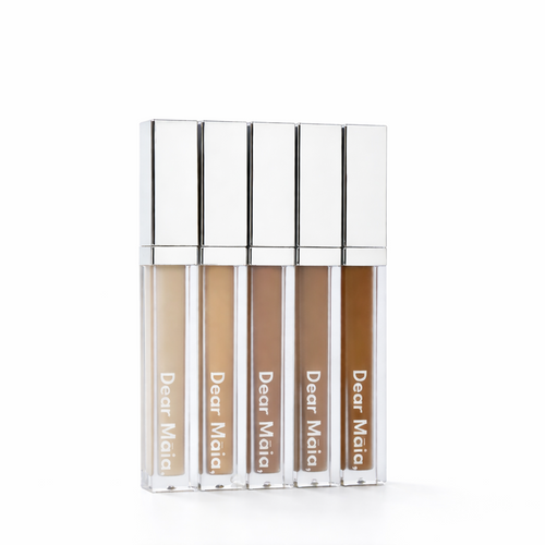 Five concealer tubes with 'Dear Mala' branding on a white background. Displaying the five shades of the flawless awakening concealer ranging from light to deep