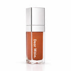 Luminous liquid blush acrylic bottle with silver cap and a peachy golden brown blush shade inside on a white background with the Dear Māia logo