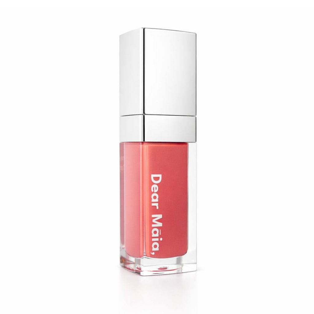 Luminous liquid blush acrylic bottle with silver cap and a muted rose pink blush shade inside on a white background with the Dear Māia logo