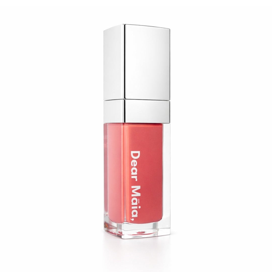 Luminous liquid blush acrylic bottle with silver cap and a muted rose pink blush shade inside on a white background with the Dear Māia logo