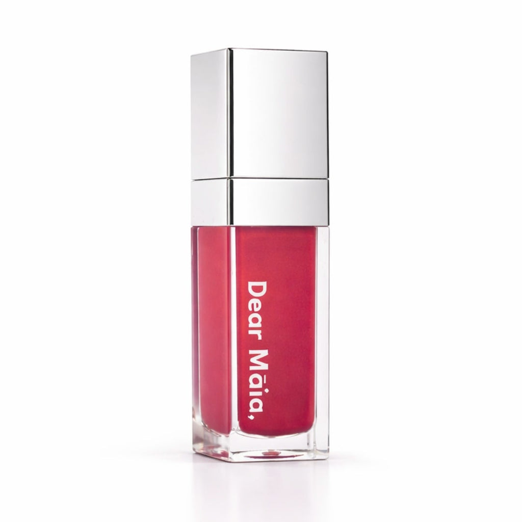 Luminous liquid blush acrylic bottle with silver cap and a hot pink blush shade inside on a white background with the Dear Māia logo